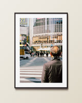 The 'Crossing Shibuya' photography print styled in a modern industrial loft, highlighting the contrast between the black-and-white street lines and the urban backdrop.