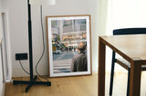 The 'Crossing Shibuya' photography print styled in a modern industrial loft, highlighting the contrast between the black-and-white street lines and the urban backdrop.